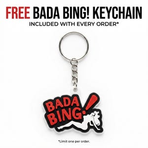 A promotional graphic showing a white keychain with the red and black Bada Bing logo, with text stating a free keychain is included with every order.