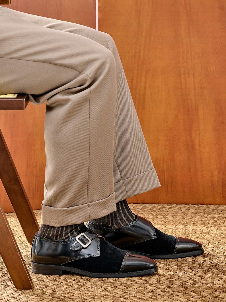 Double monk strap shoes on foot with dress trousers