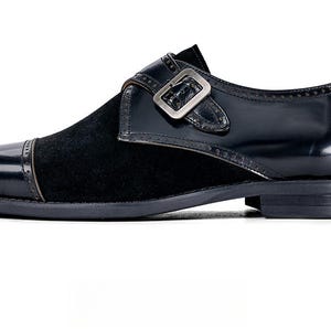 Polished leather upper close up double buckle detail