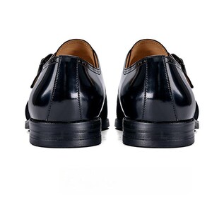 Handmade monk strap shoes pair angled view rubber sole