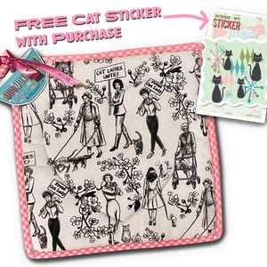May include: A white cotton pot holder with a pink gingham border. The pot holder features a black and white illustration of women walking cats with the text "Cat Ladies Unite!" and "Proud Cat Lady". The pot holder comes with a free waterproof vinyl sticker of black cats.