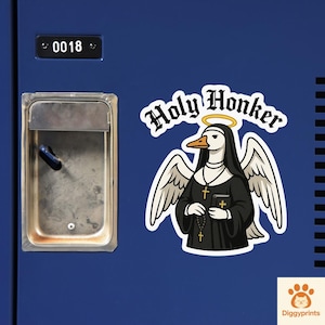 May include: A sticker featuring a cartoon duck dressed as a nun with angel wings and a halo. The text "Holy Honker" is above the duck. The sticker is on a blue background, next to a metal locker.
