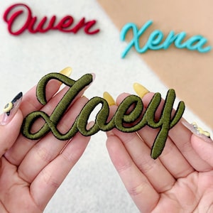 May include: Embroidered name patches in red, teal, and olive green. The names "Owen" and "Xena" are in cursive script. The name "Zoey" is held in hands. These patches are ideal for personalizing clothing or accessories.