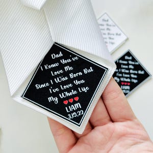 May include: White ribbon with a black and white label. The label reads "Dad I Know You've Love Me Since I Was Born But I've Love You My Whole Life" with the name "LIAM" and the date "3.19.22".