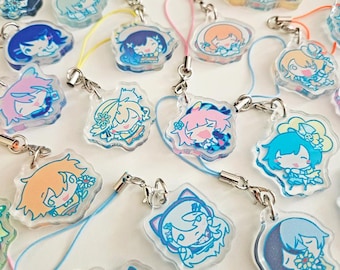 May include: A collection of clear acrylic charms featuring colorful anime-style character designs. Each charm has a silver-colored clasp and a matching colored lanyard. The characters have various hair colors and outfits.