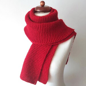 Hand gestrickter roter Schal mit schimmerndem Glanzfaden