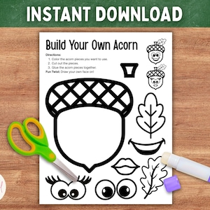 May include: A black and white printable activity sheet titled Build Your Own Acorn with instructions, a large acorn outline, and various facial features and leaf shapes to cut out. Green handled scissors and a glue stick are placed on the page.