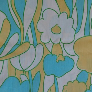 May include: Abstract floral pattern fabric in shades of yellow, blue, and green. The fabric features a repeating pattern of stylized flowers and leaves.