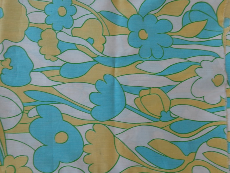 May include: Abstract floral pattern fabric in shades of blue, yellow, and white. The fabric features a repeating pattern of stylized flowers and leaves.