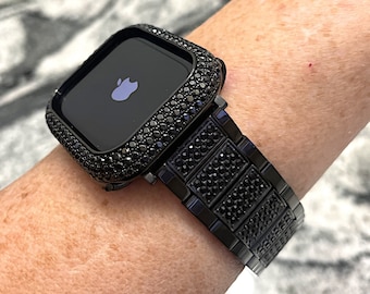 May include: A black Apple Watch with a black diamond-encrusted case and band.