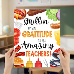 May include: A poster with the words "Grillin' Up Some Gratitude For Our Amazing Teachers!" surrounded by illustrations of grilled food items like a hamburger, hot dog, steak, and vegetables. The poster is held up in a classroom.