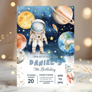 May include: A space-themed birthday invitation featuring an astronaut, planets, and a rocket against a starry blue background. The invitation reads "Daniel's 5th Birthday" with event details. Gold accents add a touch of elegance.