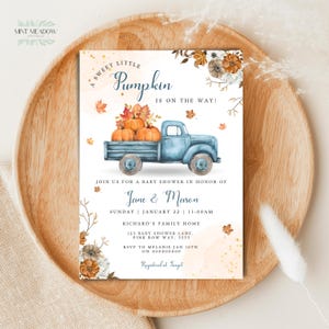 May include: A rectangular baby shower invitation card featuring a blue vintage truck carrying orange pumpkins. The text reads A SWEET LITTLE PUMPKIN IS ON THE WAY, JOIN US FOR A BABY SHOWER IN HONOR OF Jane & Mason, SUNDAY JANUARY 22 11:00AM, RICHARD'S FAMILY HOME, 123 BABY SHOWER LANE, PINK BOW WAY, 5555, RSVP TO MELANIE JAN 16TH ON 000000000, Registered at Target.