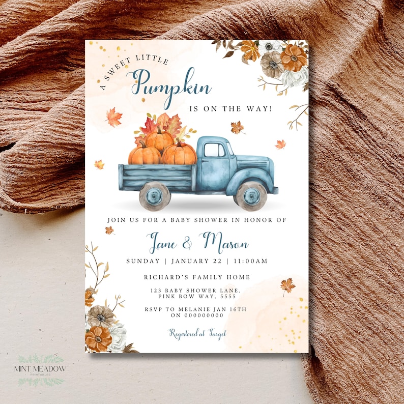 May include: A baby shower invitation card featuring a watercolor blue truck carrying pumpkins, surrounded by autumn leaves and flowers. The text reads A SWEET LITTLE PUMPKIN IS ON THE WAY, JOIN US FOR A BABY SHOWER IN HONOR OF Jane & Mason, and event details.