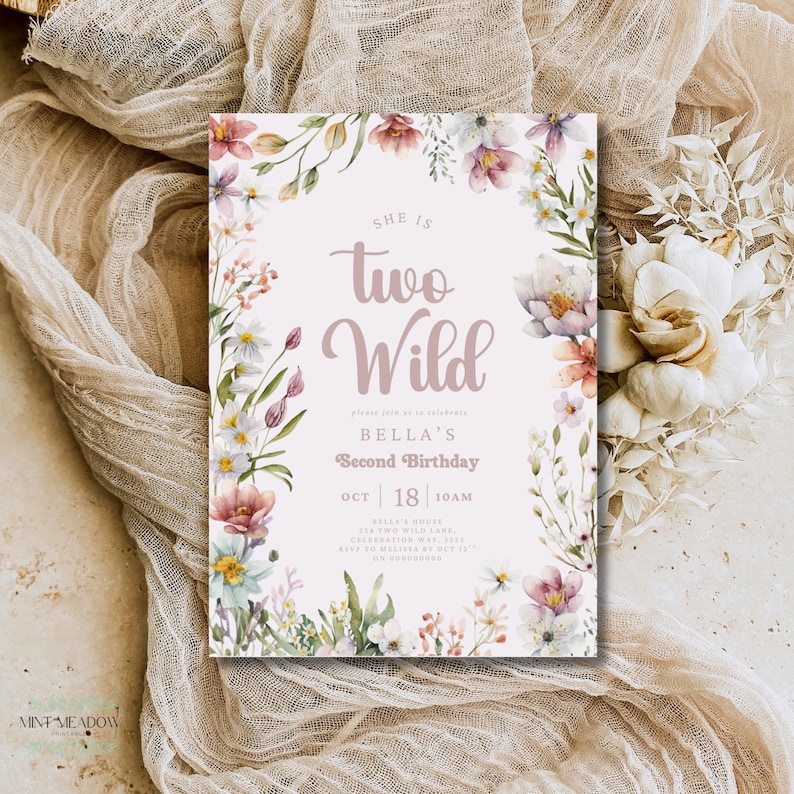 May include: A floral-themed birthday invitation with the text "She is Two Wild" in a soft pink hue. The invitation includes details for Bella's second birthday, surrounded by watercolor flowers in pink, white, and purple. The design is set against a neutral background.