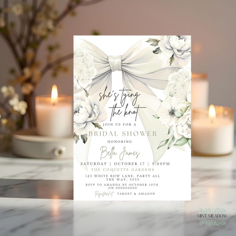 May include: Bridal shower invitation with a large white bow and floral accents. The invitation reads "She's tying the knot" and includes event details such as date, time, and location. The design is elegant and features soft colors.