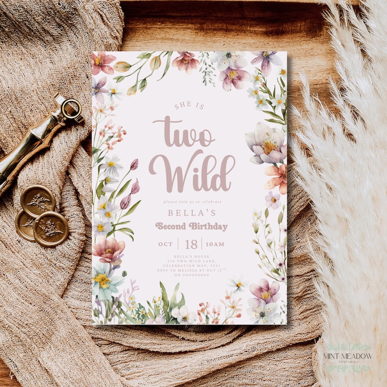 May include: A floral-themed birthday invitation with the text "She is Two Wild" in a soft, mauve script. The invitation is framed by watercolor flowers in shades of pink, white, and green. The details include the date, time, and location.