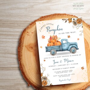 May include: A rectangular baby shower invitation card featuring a blue pickup truck carrying orange pumpkins. The text reads A SWEET LITTLE PUMPKIN IS ON THE WAY! JOIN US FOR A BABY SHOWER IN HONOR OF JANE & MASON SUNDAY JANUARY 22 11:00AM.