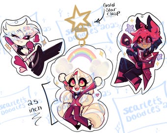 May include: Three character-shaped acrylic keychains. The keychains feature cartoon characters in various poses, with a rainbow and star accents. The keychains are approximately 2.55 inches in height and are attached to a gold star clasp.