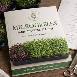 May include: A softcover book titled Microgreens Farm Business Planner with a cover image of a tray of green and purple microgreens. The book features the text Plan. Grow. Succeed. and A4 Planner | Track | Grow | Thrive. A pen and scissors are nearby.