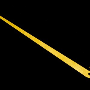 May include: A gold-colored metal crochet hook with a long, thin handle and a hook at each end.