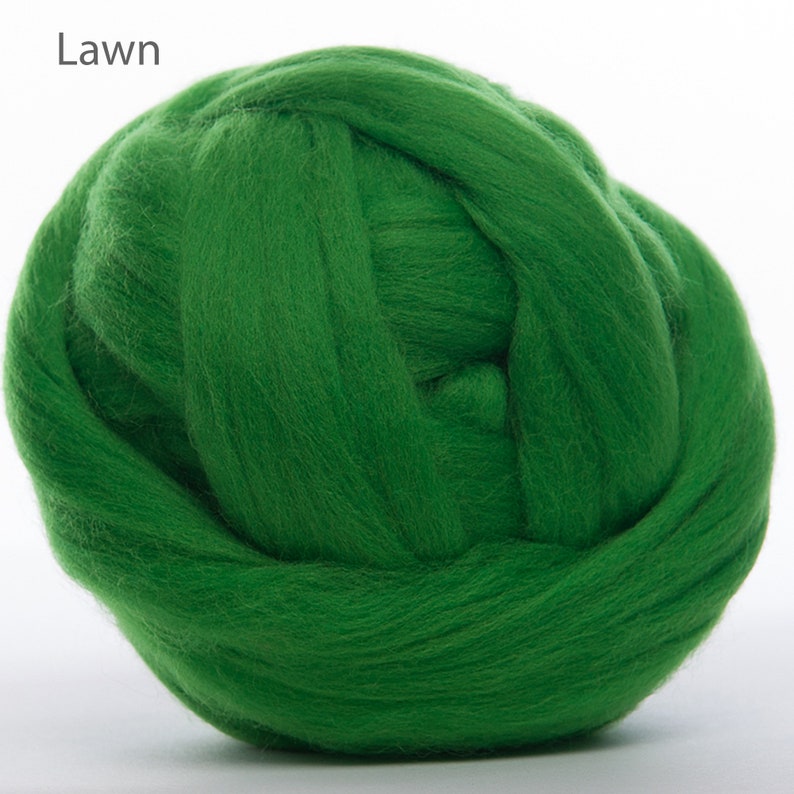 May include: A ball of green wool roving, a type of fiber used for felting and spinning.