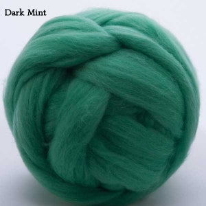 May include: A ball of dark green wool roving. The wool is soft and fluffy, and it is perfect for felting or spinning.