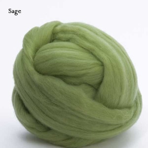 May include: A ball of sage green wool roving. The wool is soft and fluffy, perfect for felting or spinning.