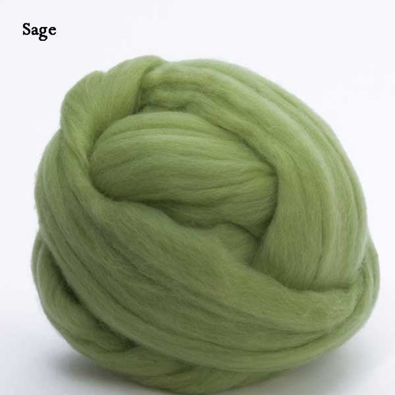 May include: A ball of sage green wool roving. The wool is soft and fluffy, perfect for felting or spinning.