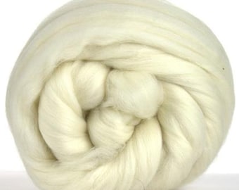 May include: A close-up of a ball of white wool fiber. The wool is soft and fluffy, and it is perfect for spinning or felting.
