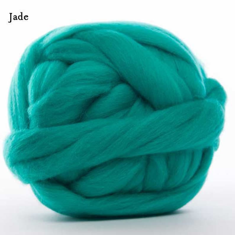May include: A large ball of teal blue wool yarn. The yarn is soft and fluffy, and it is perfect for knitting or crocheting.