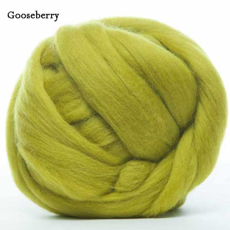 May include: A ball of light green wool roving. The wool is soft and fluffy, and it is perfect for felting or spinning.