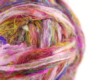 May include: A close-up of a ball of colorful yarn, featuring shades of pink, purple, blue, green, yellow, and white. The yarn is made of recycled materials and is perfect for crafting.