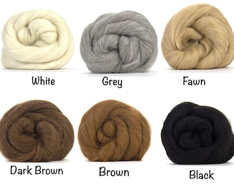 May include: Six balls of wool in different colors: white, grey, fawn, dark brown, brown, and black.