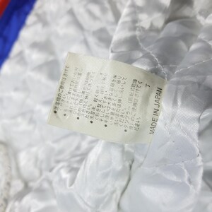 May include: Close-up of a white quilted fabric with a tag attached. The tag has Japanese text and the words "MADE IN JAPAN". The fabric appears to be part of a garment's lining.
