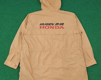 May include: Tan hooded jacket with the text "MUGEN 無限 HONDA" in red and black. The jacket has a drawstring waist, long sleeves, and a hood. The jacket is made of a lightweight material and is suitable for outdoor wear.