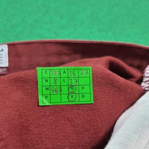 May include: A white ceramic mug with a black handle and the text "But First, Coffee" in a black, handwritten-style font. The mug is on a white surface.