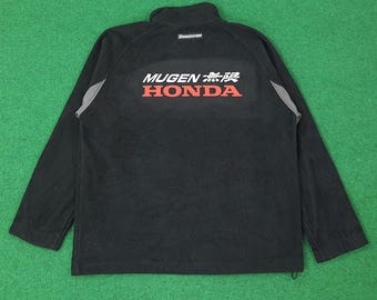 May include: Black long-sleeved fleece jacket with the text "MUGEN 無限 HONDA" in red and white. The jacket has a high collar and gray accents on the shoulders. The Bridgestone logo is at the top.