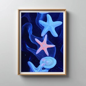 May include: A framed print featuring a vibrant underwater scene. The artwork showcases several starfish in shades of blue and coral against a dark blue background. The starfish are the focal point, with a swirling, abstract design adding depth.
