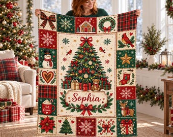 May include: A rectangular throw blanket featuring a central Christmas tree with gifts and a teddy bear, personalised with the name Sophia. The border consists of various festive squares including a snowman, cardinal, reindeer, and candy canes.