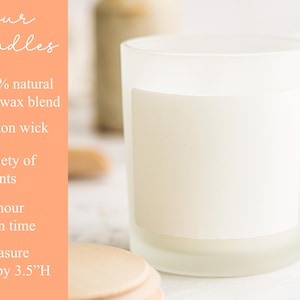 May include: A frosted glass candle with a blank white label. Text on the left reads: our candles, 100% natural soy wax blend, Cotton wick, Variety of scents, 35 hour burn time, Measure 7.62 cm by 8.89 cm H. The candle has a cylindrical shape and clear glass.