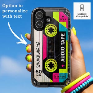 May include: A clear phone case featuring a retro cassette tape graphic with neon yellow reels, pink accents, and the text "SUMMER MIX '98", "60 MIN", "STEREO", and "AUDIO TAPE". The case includes a MagSafe compatible icon and text indicating an option to personalize with text.