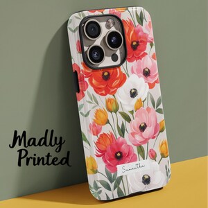 May include: A floral phone case featuring a vibrant design of red, pink, and white flowers with green leaves. The case has the text "Madly Printed" and the name "Samantha".