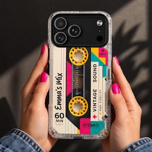 May include: A clear smartphone case featuring a graphic design of a vintage cassette tape. The design includes yellow reels, pink and teal accents, and text that reads Emma's Mix, 60 MIN, VINTAGE SOUND, HIGH FIDELITY, and STEREO, with a Side A label.