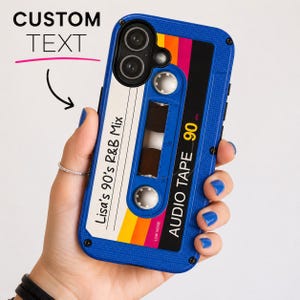 May include: A blue smartphone case featuring a retro cassette tape design with a white label printed with the text 'Lisa's 90's R&B Mix' and 'AUDIO TAPE 90'. The design includes horizontal yellow, orange, and pink stripes and two white spools.
