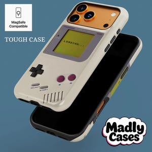 Personalized arcade style phone case with MagSafe, colorful retro gaming icons, vintage 80s 90s handheld console look, shown on wooden table for iPhone Galaxy Pixel