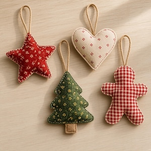 May include: Four fabric ornaments with jute hanging loops. A red star with white floral print, a cream heart with red floral print, a dark green tree with yellow floral print, and a red and white gingham gingerbread person figure.