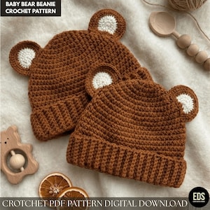 May include: Two brown crocheted baby bear beanies with white ear accents. The hats have a ribbed brim and bear-shaped ears. The text "BABY BEAR BEANIE CROCHET PATTERN" is at the top. The text "CROCHET PDF PATTERN DIGITAL DOWNLOAD" is at the bottom.