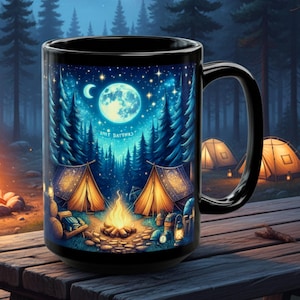 May include: Black ceramic mug featuring a camping scene under a full moon and starry sky. The design includes tents, a campfire, and pine trees. The mug is set on a wooden picnic table, with a forest backdrop.