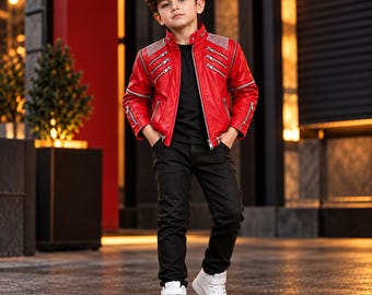 May include: A bright red jacket with a stand-up collar, silver-toned zips, and studded shoulder panels, worn over a plain black t-shirt and black trousers, paired with white high-top trainers featuring a hook-and-loop strap closure.